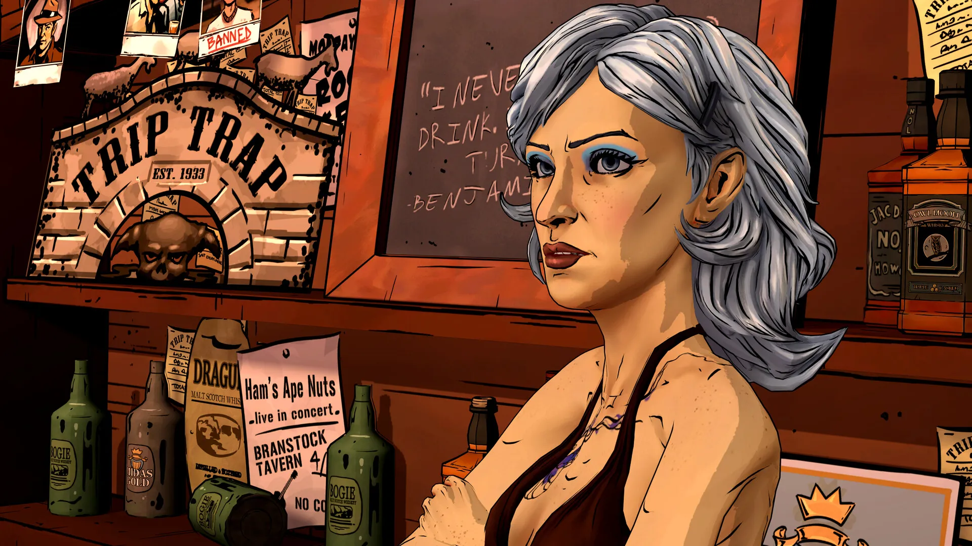 A woman with long silver hair and dark lipstick behind a bar, with a sign reading Trip Trap and bottles on the counter.